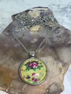 If you love vintage vibes, you'll love this beautiful floral cabochon pendant necklace.  This cabochon pendant necklace is made with gorgeous yellow, floral cotton fabric with a glass dome overlay. The dome glass sits in a silver tray pendant. It gives off such beautiful vintage vibes😍.  It hangs on a 25" stainless steel, non -tarnishing cable chain with a lobster claw clasp. It would make the perfect Mother's Day gift 💝. Handmade Retro Necklace, Handmade Vintage Flower Necklace, Vintage Flower Necklace For Gift, Vintage Handmade Necklace As Gift For Her, Vintage Necklace For Mother's Day Gift, Vintage Flower-shaped Nickel-free Necklaces, Retro Necklaces With Lobster Clasp For Gifts, Retro Necklaces With Lobster Clasp As A Gift, Retro Necklace With Lobster Clasp As Gift