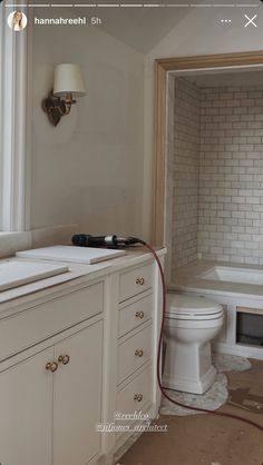 a bathroom with a toilet, sink and bathtub is shown in this image on the phone