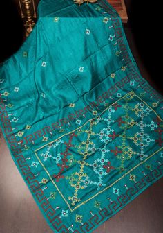 Step into elegance with this Teal Gachi Tussar Silk Saree, featuring exquisite hand embroidery that showcases traditional craftsmanship. The saree is crafted from luxurious Gachi Tussar silk, known for its rich texture and natural sheen, highlighted by a captivating teal hue. Adorned with intricate hand embroidery, the saree displays delicate patterns that add a touch of sophistication and artistry. Complementing the embroidery are detailed Pitta work and mirror accents, which bring a subtle sparkle and enhance the saree's overall allure. Perfect for special occasions and festive celebrations, this saree seamlessly blends classic artistry with contemporary elegance, making it a standout addition to any wardrobe. Ready to wear with fall and pico done. An unstitched blouse fabric is included Pitta Work, Tussar Silk Saree, Mirror Work, Blouse Fabric, Rich Textures, Silk Saree, Silk Sarees, Hand Embroidery, Favorite Outfit