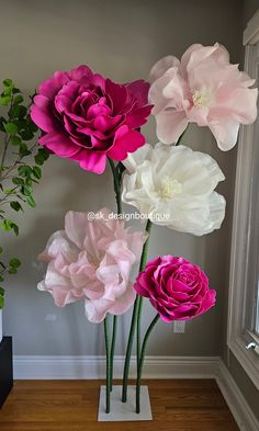 pink and white flowers are in a vase