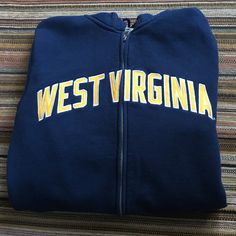 Nike West Virginia Hoodie Size Small Full Zip Up Front Navy Blue With Gold Lettering. New Without Tags Blue Collegiate Long Sleeve Hoodie, Nike West, Fall Blue Moisture-wicking Hoodie, Collegiate Moisture-wicking Hooded Hoodie, Blue Hooded Moisture-wicking Sweatshirt, Blue Moisture-wicking Hooded Hoodie, West Virginia University, Gold Lettering, Colorful Hoodies