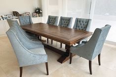 a large wooden table with blue chairs around it