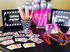 a table topped with lots of different types of items on top of a black table