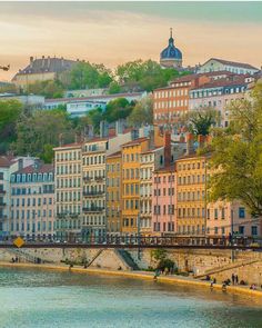 many buildings line the bank of a river