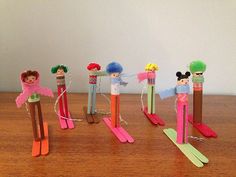 the wooden toy skis are lined up on the table with different types of toys