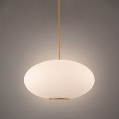 a white light hanging from the ceiling in a room with grey walls and flooring