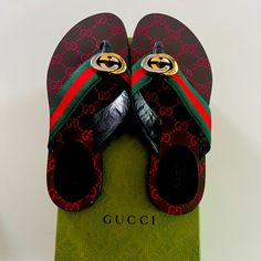 Gucci Sandals In Leather And Green/Red/Green Web. Flat Heel. Thong Strap With Interlocking Two-Tone Gg Center. Slide Style. Gg Supreme-Print Footbed. Smooth Outsole. Size Note: Item Runs Small These Sandals Have Now Gone Up In Price To $680 Designer Gucci Sandals With Single Toe Strap, Gucci Designer Sandals With Single Toe Strap, Designer Flat Flip Flops For Beach, Designer Multicolor Sandals For Vacation, Designer Open Toe Flip Flops For Vacation, Designer Multicolor Beach Sandals, Designer Flip Flops For Beach, Luxury Flip Flops, Designer Red Sandals For The Beach