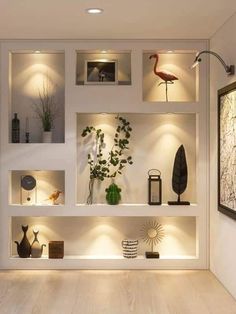 a living room filled with lots of furniture and lighting on top of white shelving