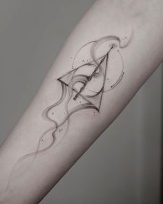 a black and white photo of a tattoo on the arm