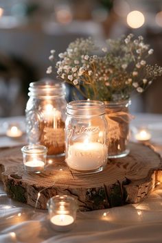 mason jars filled with candles on top of a table