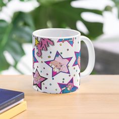 a white coffee mug sitting on top of a wooden table