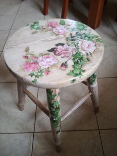 a small table with flowers painted on it