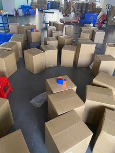 many cardboard boxes are scattered on the floor