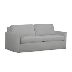 a white couch sitting on top of a white floor