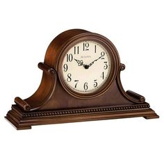 an old fashioned wooden clock with roman numerals