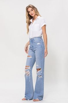 A nostalgic and stylish choice that pays homage to the iconic denim trends of the 90s. These jeans feature a high-rise waist, a non-stretch denim construction, distressed details, and a raw hemline, capturing the essence of vintage style.F. Rise: 11.5" / Inseam: 34" / Leg Opening: 20"Model is 5'9" and wearing size 26 Style: Vintage Print / Pattern: Light Denim Silhouette: Flare Fit: Relaxed Embellishment: Distressed Neck Line: NA Sleeve: NA Length: Full Length Closure: Zip Fly Lining: No Made In Vintage Flare Jeans, Stretch Denim Fabric, Light Flare, Stylish Jeans, Vintage Flare, Flying Monkey, Denim Trends, Light Wash Jeans, Cute Sweaters