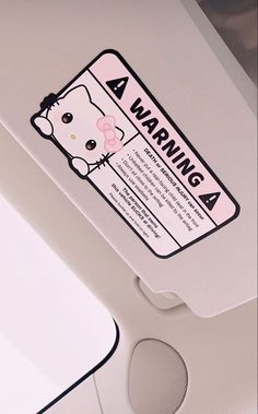 a sticker on the side of a door that says warning 4 with an image of a hello kitty