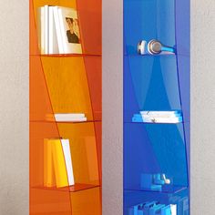 an orange and blue book shelf next to each other