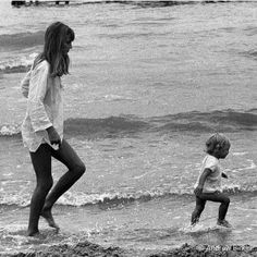 two children playing in the water at the beach