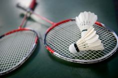 two badminton racquets sitting on top of each other