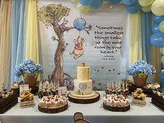 a winnie the pooh themed birthday party with balloons and desserts on a table