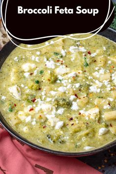 broccoli feta soup in a black bowl on top of a pink towel