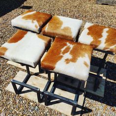 four brown and white stools sitting on top of each other