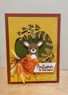 an autumn card with a deer and leaves