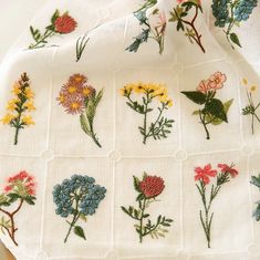 a white cloth with flowers embroidered on it