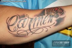 a man with a crown on his arm that says,'gamer'in cursive writing