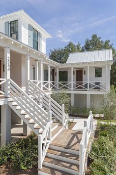 two white houses with stairs leading to them