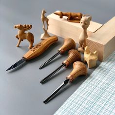 wooden carving tools are lined up on a table