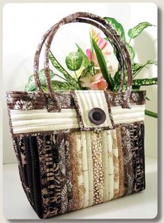 a handbag is sitting on a table next to a potted plant