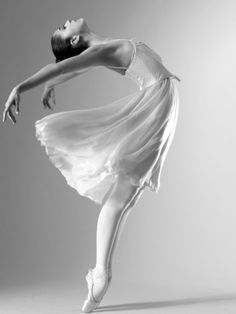 a ballerina in white is posing for the camera with her arms stretched out and legs spread wide