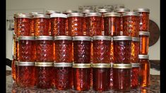 many jars are stacked on top of each other in the middle of a countertop