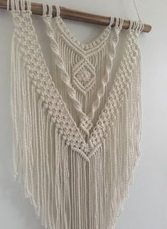 a white macrame hanging on a wall