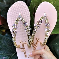 Description The beautiful rhinestone and customizable Flip Flops for the beach brides, bridesmaids, vacation, honeymoon or any occasion you desire to look gorgeous. Perfect in any outfit! Being unique and stunning on design, these flip flops must be your must-have item! The sandal is anti-slip, comfortable and durable as it is made from high quality rubber from the South of Thailand, where is famous for the best rubber tree. Moreover, the crystals are decorated on the sandal with effective adhes Bling Open Toe Sandals For Beach, Glamorous Pink Wedding Shoes For Summer, Pink Rhinestone Flip Flops For Summer, Adjustable Pink Sandals With Rhinestones, Pink Adjustable Sandals With Rhinestones, Elegant Bling Sandals For The Beach, Glamorous Bedazzled Wedding Sandals, Pink Rhinestone Party Flip Flops, Glamorous Pink Sandals For Beach