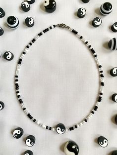 A cute and aesthetic necklace that matches any outfit! Pearl Necklace Yin Yang, Casual Black Beaded Choker Necklace, Trendy Handmade White Necklace, Casual Black Bead Jewelry For Festivals, Trendy White Handmade Necklace, Trendy Crystal Necklace With Beaded Chain, Trendy White Beads For Festival, Trendy White Beaded Chain Choker, Casual White Necklaces With Letter Beads