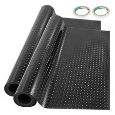 two pieces of black rubber flooring with white rings on the top and one piece in front