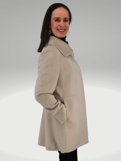 Rendered in luxurious Baby SURI Alpaca and Merino Wool, the coat is sumptuously supple and fits to flatter. Designed by one of Peru's finest coat makers, the coat drapes wonderfully for a perfectly feminine fit. It's mid-length enhances its versatility, so it can easily transition from a day-to-night look. STYLING Casual Styling Wear over your favorite jeans and tee for everyday elegance with minimal effort and fuss. Office Wear Power through a presentation or meeting with this rich wrap coat. T Elegant Cream Wool Coat With Notch Lapel, Elegant Beige Wool Coat With Concealed Placket, Beige Fitted Wool Coat With Concealed Placket, Fitted Beige Wool Coat With Concealed Placket, Elegant Cream Pea Coat For Formal Occasions, Elegant Cream Pea Coat With Long Sleeves, Elegant Cream Wool Coat With Long Sleeves, Fitted Long Beige Sweater Coat, Elegant Cream Pea Coat