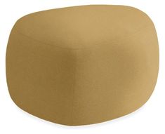 a large round ottoman with a tan cover on it's back and bottom half