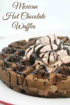 mexican hot chocolate waffles on a plate with whipped cream and chocolate drizzle