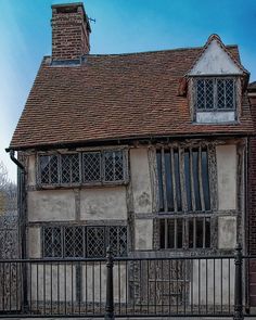 an old building with a clock on the side of it's face and windows