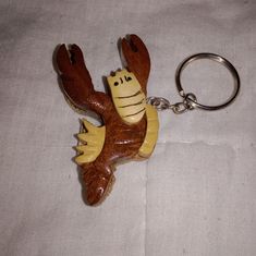 a plastic keychain with a cartoon character on it's back and arms