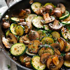 a skillet filled with cooked vegetables on top of a table