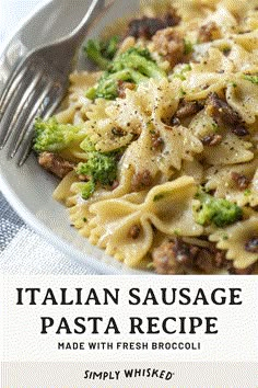 a white plate topped with pasta and broccoli next to a fork on top of a table