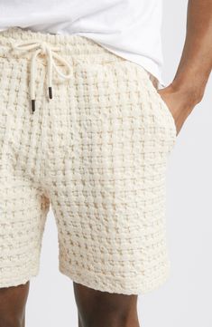 A grandly scaled waffle knit brings rich texture to these cotton shorts that give your relaxed weekend look plenty of head-turning style. 6 1/2" inseam; 24" leg opening; 12" front rise; 16" back rise (size Medium) Elastic/drawstring waist Front slant pockets; back welt pocket 100% cotton Machine wash, dry flat Made in Portugal Men's Swimwear, Knit Shorts, Mens Swimwear, Knit Cotton, Waffle Knit, Cotton Shorts, Welt Pocket, Drawstring Waist, Portugal