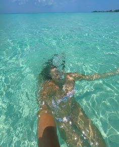 a person is swimming in the clear blue water