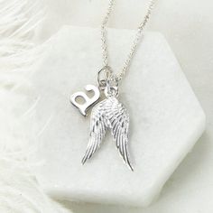 Our gorgeous Sterling Silver Guardian Angel Necklace make the perfect gift for friends and family of all ages. The design features two beautifully detailed angel wings which you can personalise with addition of an initial letter. We all need an Angel watching over us sometimes and this lovely sterling silver necklace is a great way of making someone feel loved and protected. Each necklace comes with a sterling silver belcher chain, available in five different lengths. To make this necklace personal, select an initial letter from the drop down menu. Truly a gift which is guaranteed to please This necklace is presented in a gift box complete with a blank gift card. Wing-shaped White Gold Necklace For Gift, Silver Sterling Silver Heart Pendant Initial Necklace, Silver Heart Pendant Initial Necklace In Sterling Silver, Winged Engraved Jewelry For Gifts, Personalized Silver Charm Necklace As Gift For Her, Personalized White Gold Sterling Silver Charm Necklaces, Silver Sterling Silver Initial Necklace With Charms, Silver Angel Wings Necklace As Gift, Sterling Silver Initials Jewelry For Best Friend Gift