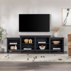 a flat screen tv sitting on top of a black entertainment center